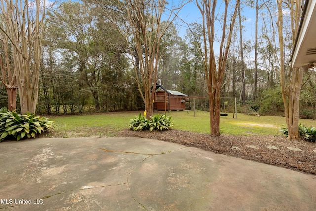 view of yard with a patio and an outbuilding