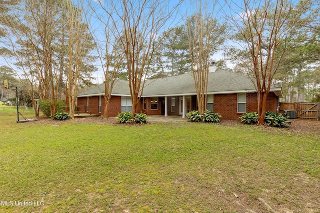 rear view of house with a yard, central air condition unit, a patio area, and fence