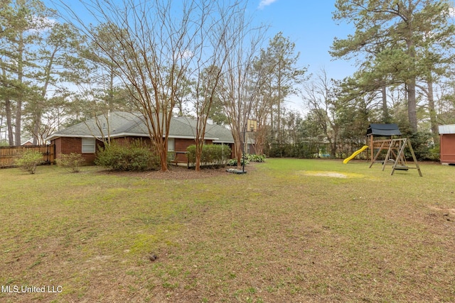 view of yard with fence and a playground