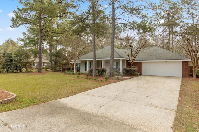 single story home with a garage, driveway, a shingled roof, and a front yard