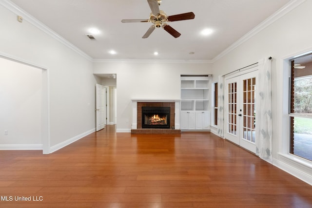 unfurnished living room featuring ornamental molding, baseboards, a ceiling fan, and wood finished floors