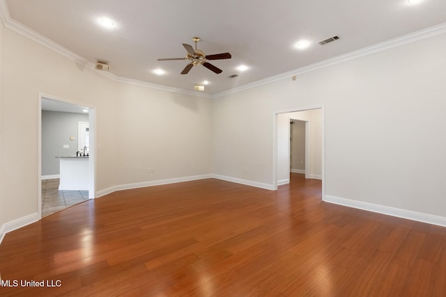 unfurnished room featuring wood finished floors, ceiling fan, and crown molding