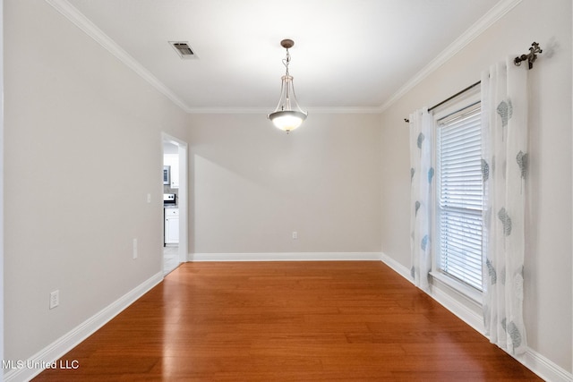 unfurnished dining area featuring visible vents, baseboards, light wood-style flooring, and ornamental molding