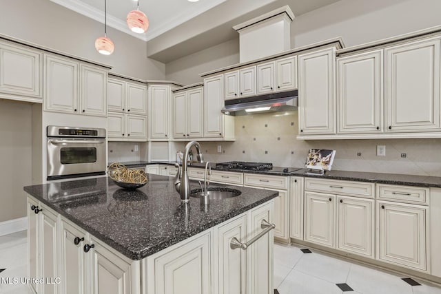 kitchen featuring hanging light fixtures, black gas stovetop, oven, and dark stone counters