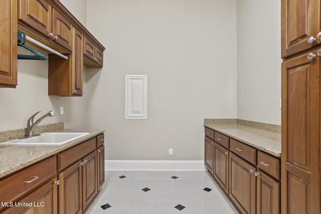 laundry area with sink and light tile patterned floors