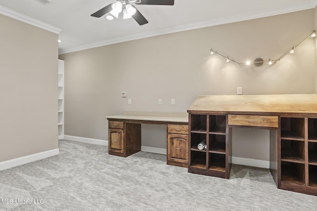 unfurnished office featuring ceiling fan, light colored carpet, ornamental molding, and rail lighting