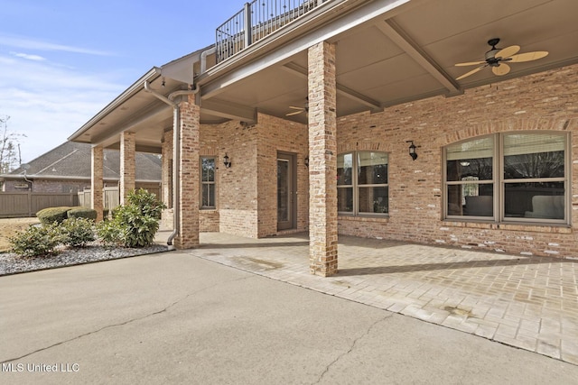 exterior space featuring a balcony and ceiling fan