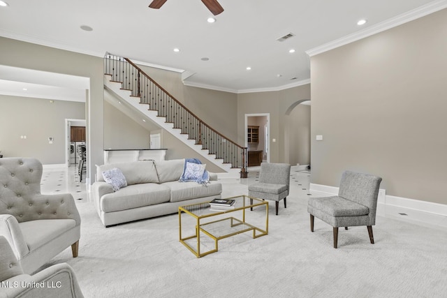 living room with crown molding, light carpet, and ceiling fan