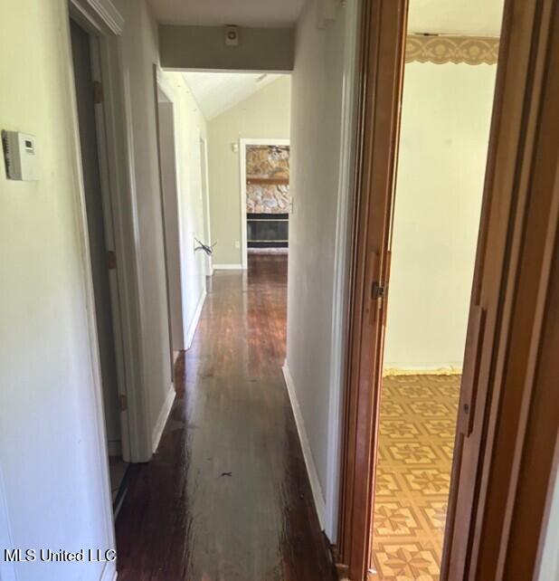 5 Union Church Rd, Tylertown, MS 39667 - hallway with dark wood-style flooring, lofted ceiling, and baseboards