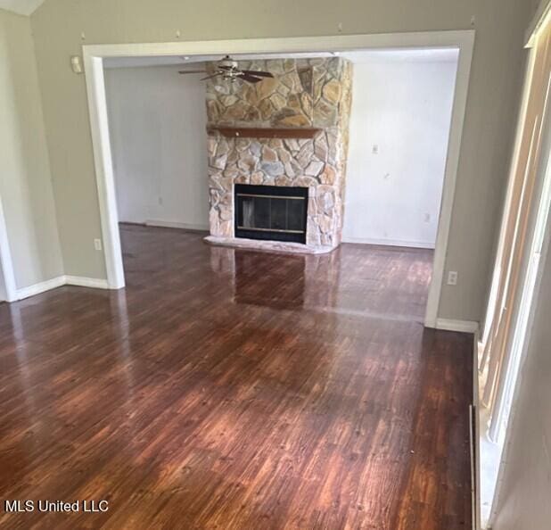 5 Union Church Rd, Tylertown, MS 39667 - unfurnished living room featuring wood finished floors, a ceiling fan, a fireplace, and baseboards