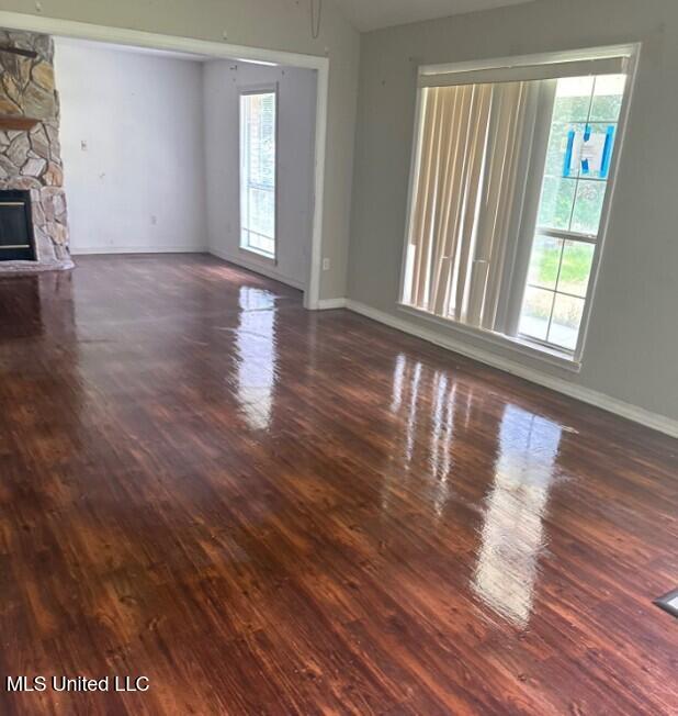5 Union Church Rd, Tylertown, MS 39667 - unfurnished living room featuring plenty of natural light, baseboards, and wood finished floors