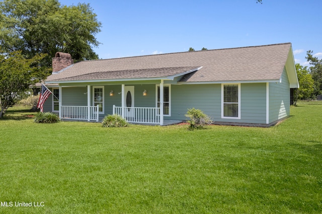 ranch-style home featuring covered porch and a front lawn