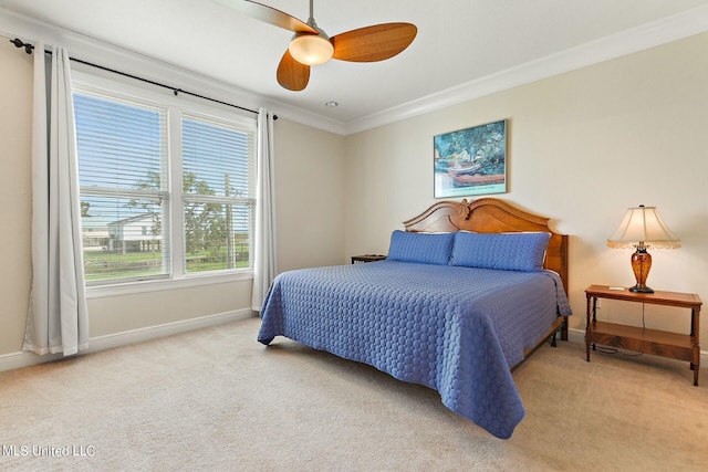 bedroom featuring ceiling fan, light carpet, and crown molding