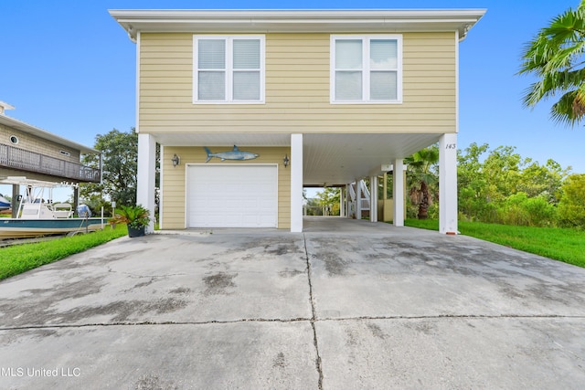 view of home's exterior with a carport and a garage