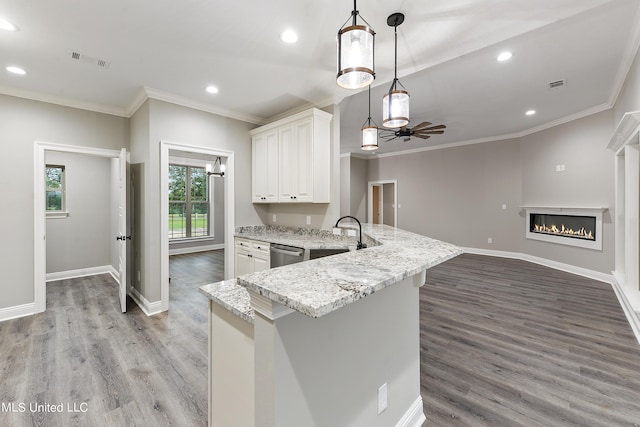 kitchen featuring decorative light fixtures, white cabinetry, light hardwood / wood-style floors, sink, and stainless steel dishwasher