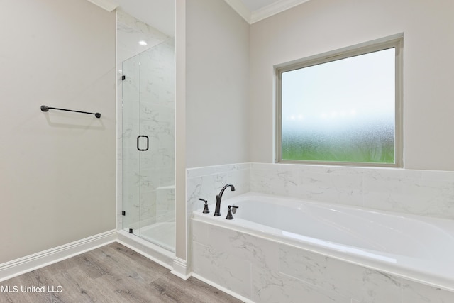 bathroom featuring hardwood / wood-style flooring, ornamental molding, and independent shower and bath