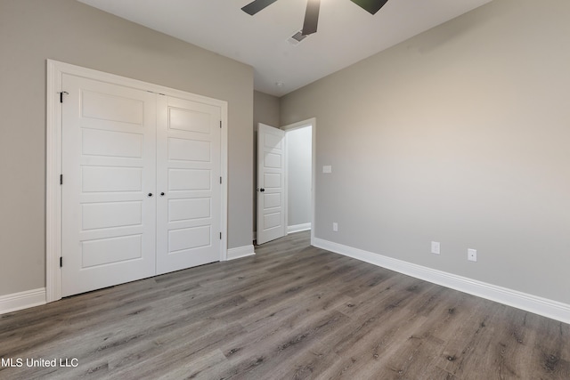 unfurnished bedroom with a closet, ceiling fan, and hardwood / wood-style floors