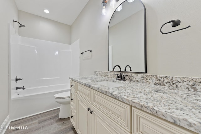 full bathroom featuring vanity, toilet, hardwood / wood-style floors, and shower / washtub combination