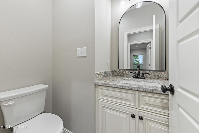 bathroom featuring toilet and vanity