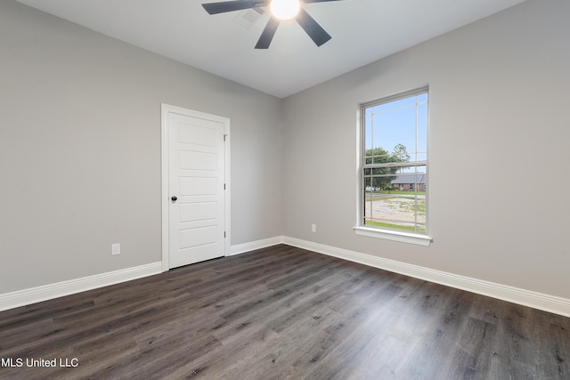 empty room with ceiling fan and dark hardwood / wood-style flooring