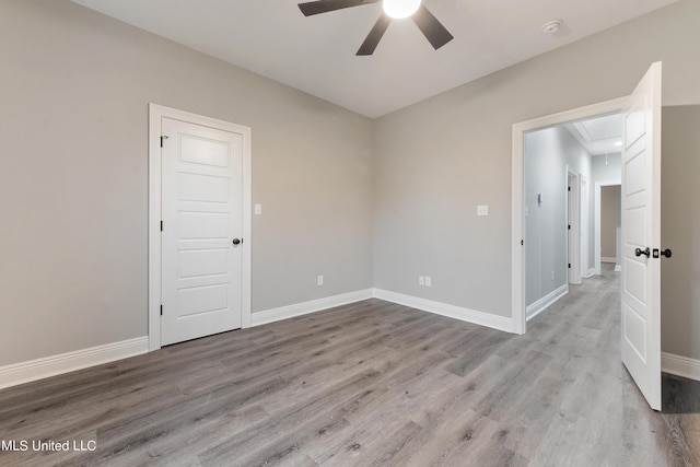 spare room featuring light hardwood / wood-style flooring and ceiling fan