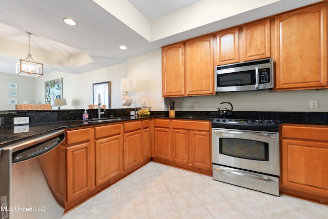 2668 Beach Blvd Unit 304, Biloxi, MS 39531 - kitchen with appliances with stainless steel finishes, dark stone counters, a sink, brown cabinetry, and recessed lighting