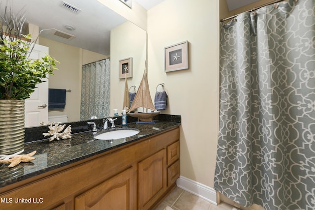 2668 Beach Blvd Unit 304, Biloxi, MS 39531 - full bathroom with tile patterned flooring, vanity, baseboards, and curtained shower