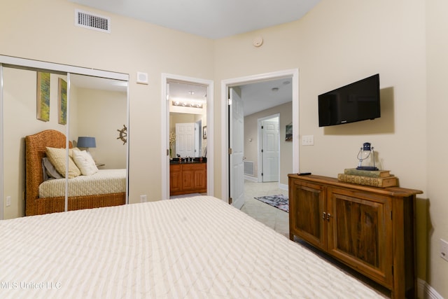 2668 Beach Blvd Unit 304, Biloxi, MS 39531 - bedroom with ensuite bathroom, a closet, and light tile patterned floors