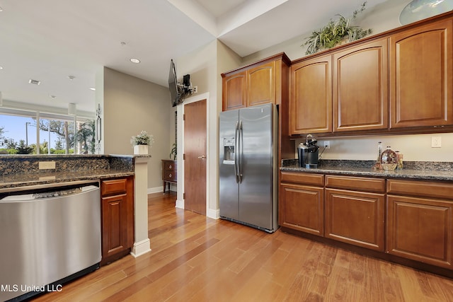 2668 Beach Blvd Unit 304, Biloxi, MS 39531 - kitchen with stainless steel appliances, light wood-style floors, recessed lighting, and brown cabinetry