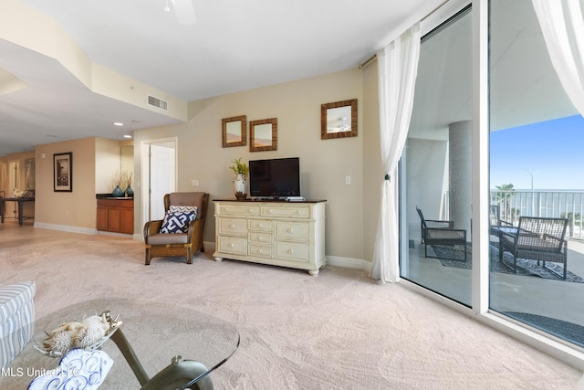 2668 Beach Blvd Unit 304, Biloxi, MS 39531 - living area with light carpet, baseboards, and a ceiling fan