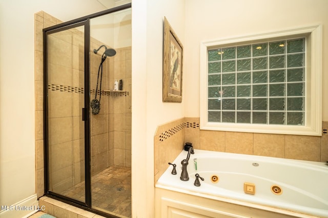 bathroom featuring shower with separate bathtub