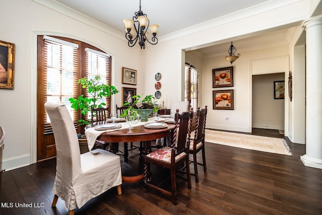 dining room featuring ornamental molding, a healthy amount of sunlight, dark hardwood / wood-style flooring, and decorative columns