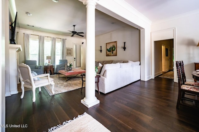 living room featuring ceiling fan, ornamental molding, dark hardwood / wood-style flooring, and decorative columns