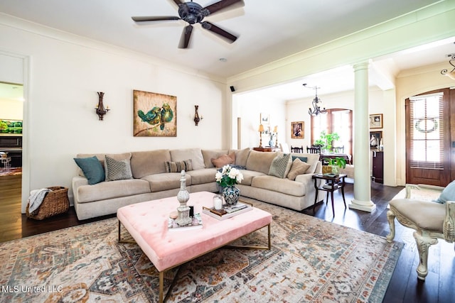 living room with ornamental molding, dark hardwood / wood-style floors, ceiling fan with notable chandelier, and ornate columns