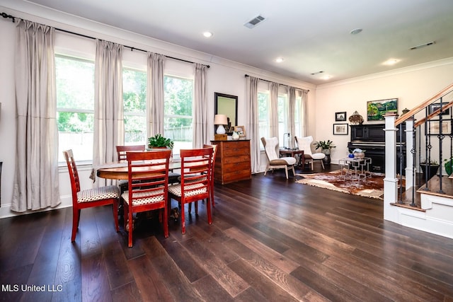 dining room with ornamental molding and dark hardwood / wood-style floors