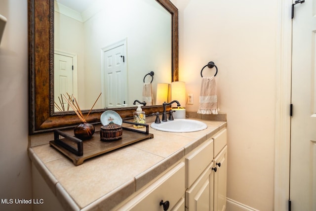 bathroom featuring crown molding and vanity