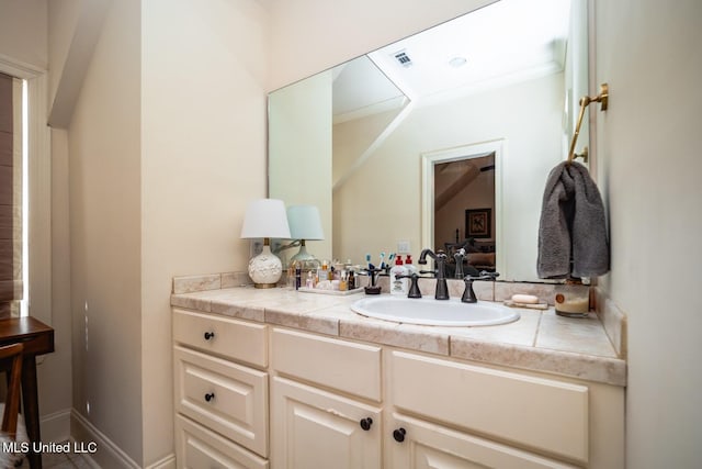 bathroom featuring vanity and ornamental molding