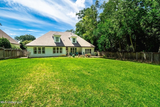 rear view of property with a lawn