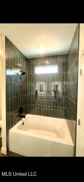full bath featuring shower / bathtub combination