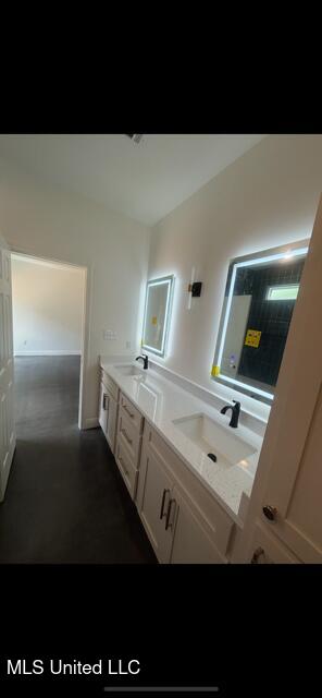 bathroom with double vanity and a sink