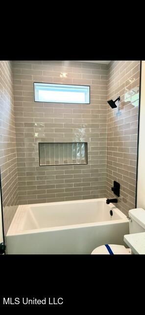 full bathroom with vanity,  shower combination, and toilet