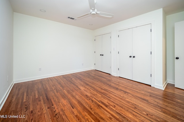 unfurnished bedroom featuring dark hardwood / wood-style floors and ceiling fan