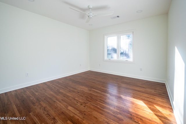 unfurnished room with ceiling fan and dark hardwood / wood-style flooring