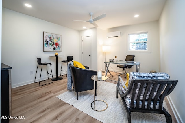 office space with ceiling fan, wood-type flooring, and a wall unit AC