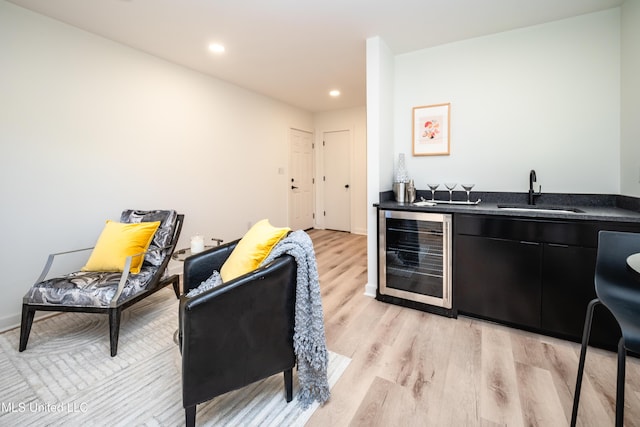 kitchen with sink, wine cooler, and light hardwood / wood-style flooring