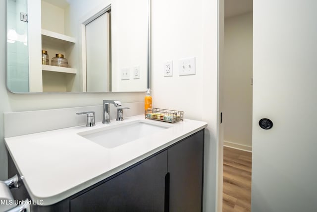 bathroom with vanity and hardwood / wood-style flooring