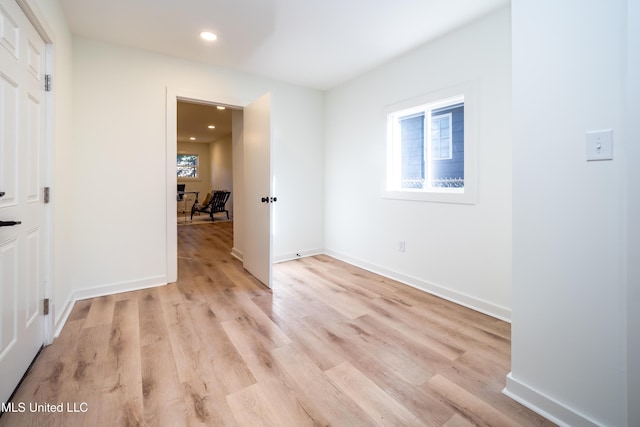 empty room with light hardwood / wood-style flooring