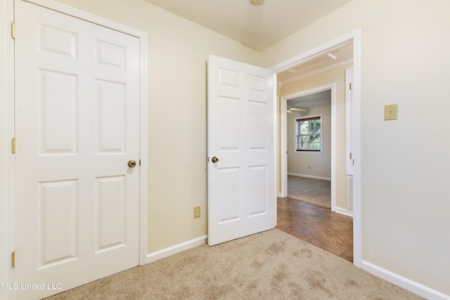 unfurnished bedroom with light carpet and a closet