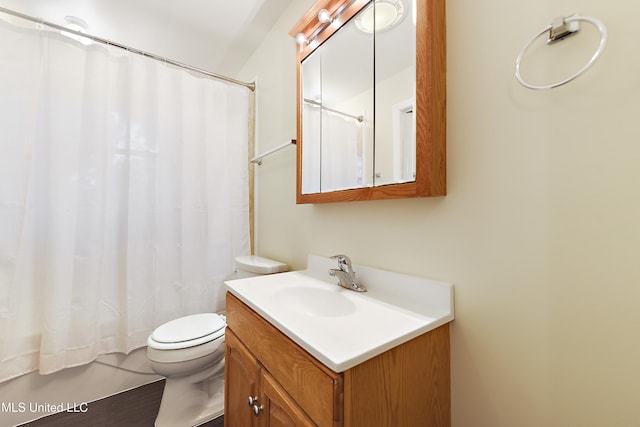 bathroom with vanity, wood-type flooring, and toilet