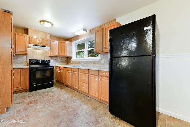 kitchen with backsplash, sink, and black appliances